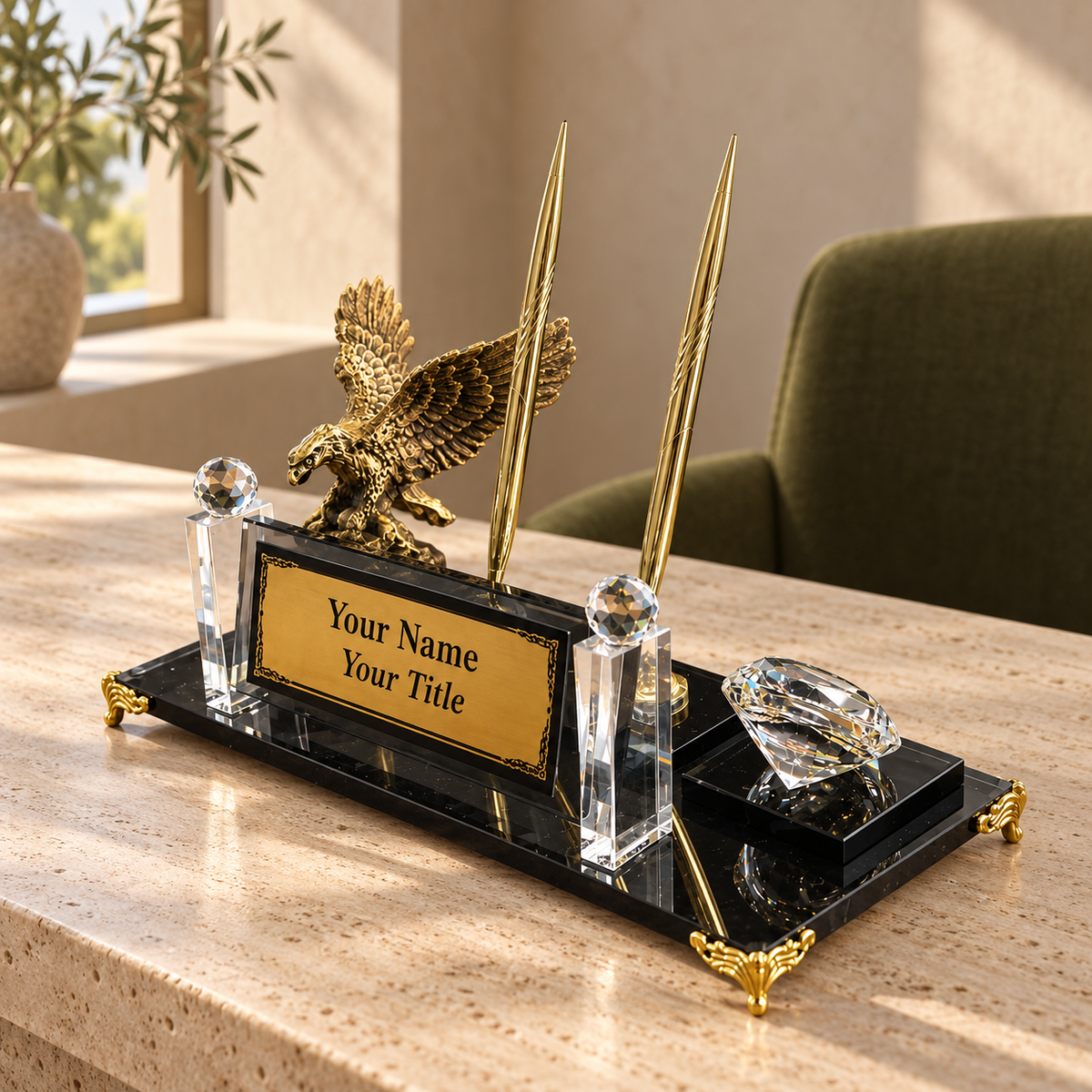Personalized desk name plate with gold eagle statue, two gold pens and crystal clock on a travertine desk